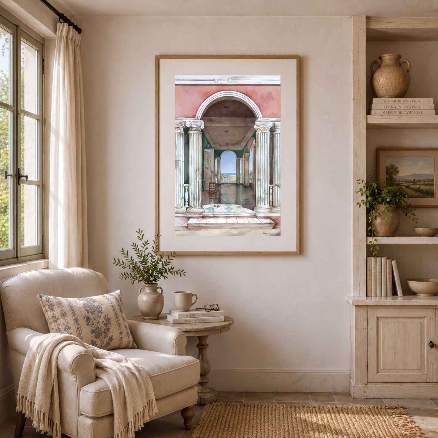 a cozy living room with a large framed painting of an archway on the wall, a comfortable armchair, a small side table with a plant, and a bookshelf filled with books and decorative items.