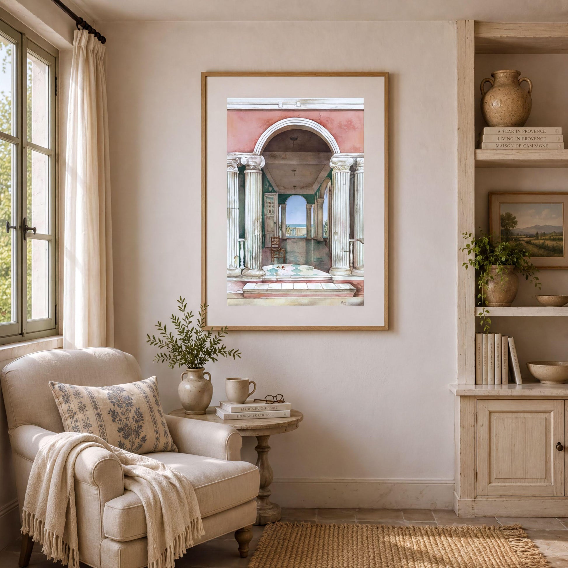 a cozy living room with a large framed painting of an archway on the wall, a comfortable armchair, a small side table with a plant, and a bookshelf filled with books and decorative items.