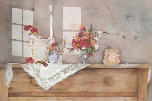 A wooden dresser with a lace tablecloth, a vase of red and pink flowers, and a small clock on top.