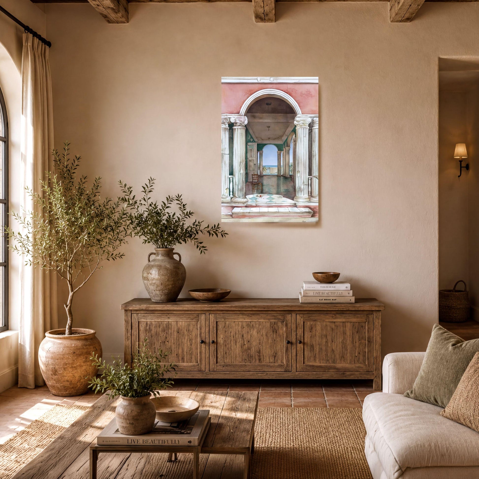 a cozy living room with a wooden coffee table, a sofa, and a wooden cabinet. A large painting of an archway with columns is hanging on the wall above the cabinet. The room is decorated with potted plants, vases, and other home decor items, creating a warm and inviting atmosphere.