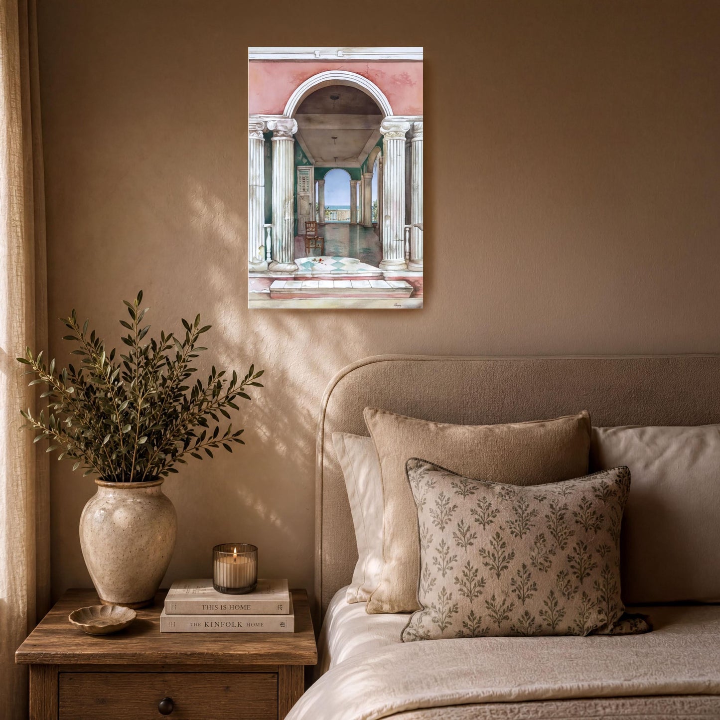 a serene bedroom scene with a bed, a nightstand, and a painting of an archway. The room has a neutral color palette, with a beige bedspread and pillows, and a vase of greenery on the nightstand. The painting adds an artistic touch to the space.