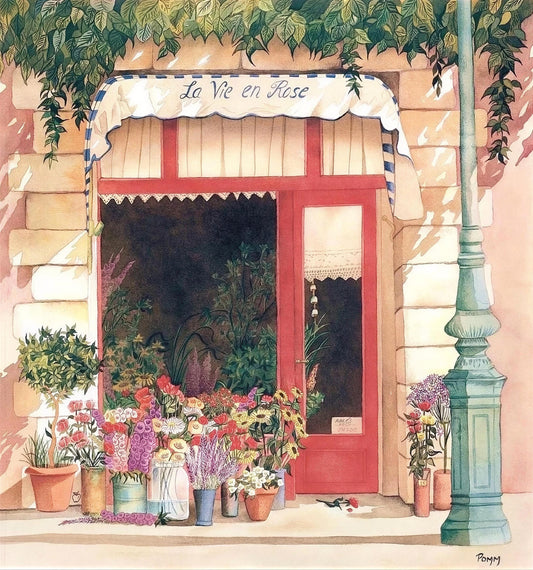 a charming flower shop with a red door and a white awning displaying the name "La Vie en Rose". The shop is filled with a variety of colorful flowers and plants, creating a vibrant and inviting atmosphere.